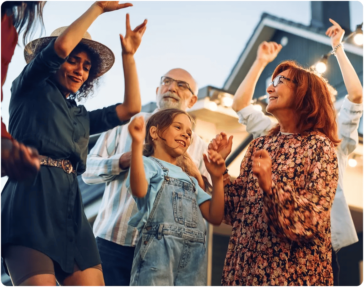 Diverse group of individuals, younger to older, dancing together. 