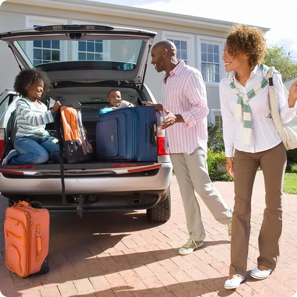 Family packing trunk of car.