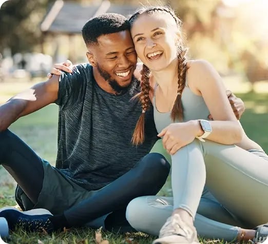 Happy couple sitting outdoors.