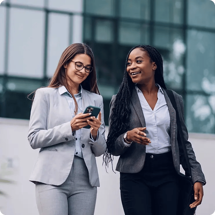 Two business woman walking together.