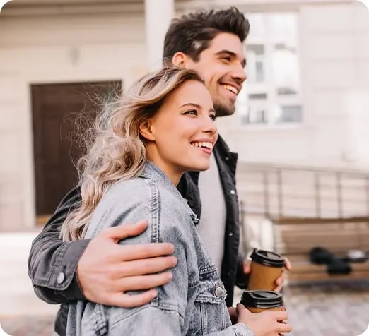 Couple walking through halls with coffee in hand. Couple walking through halls with coffee in hand.