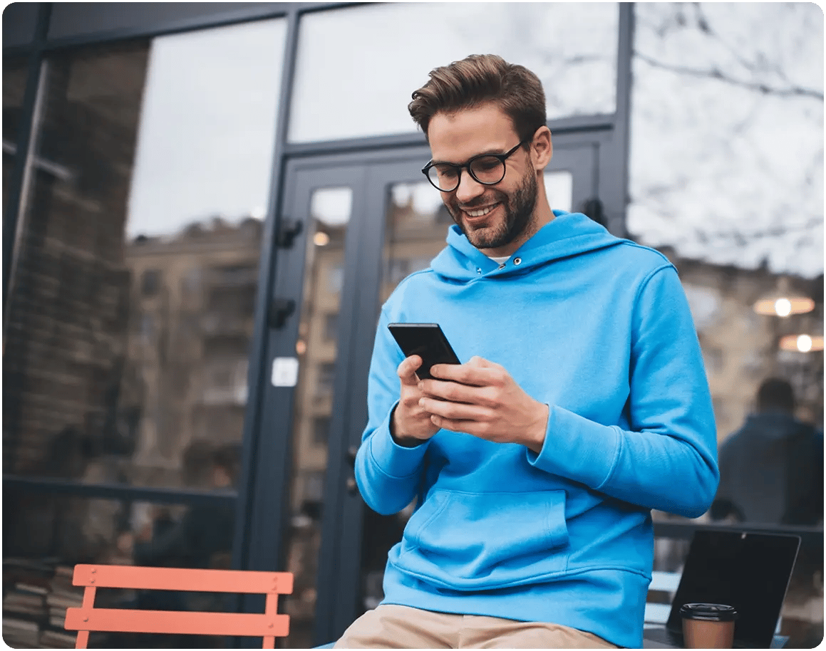 Man smiling at his phone.
